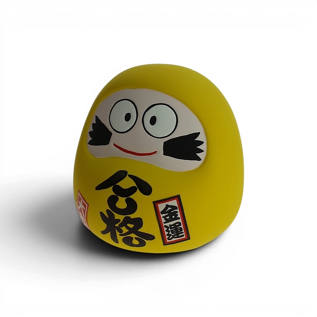 Statuette Daruma jaune en céramique avec fente tirelire, symbole japonais de persévérance et de réussite